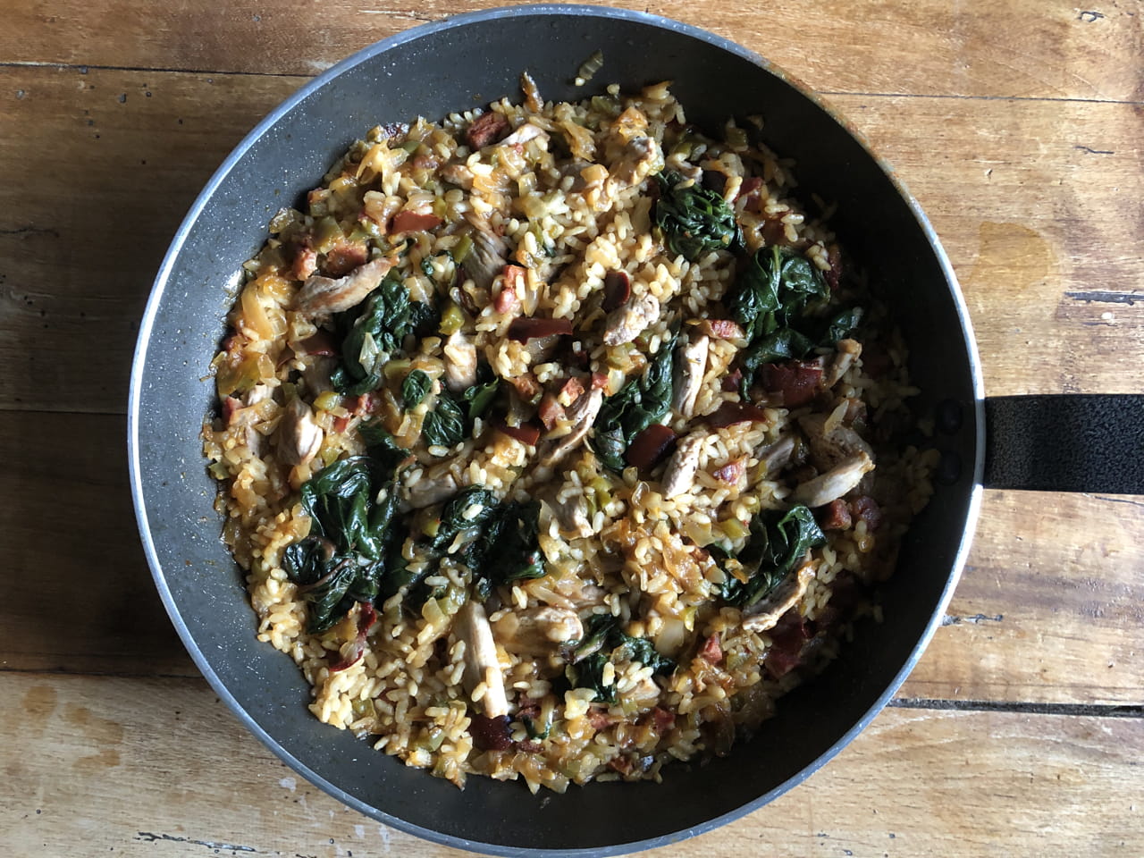 Paella with pork, chorizo and spinach and palo cortado sherry